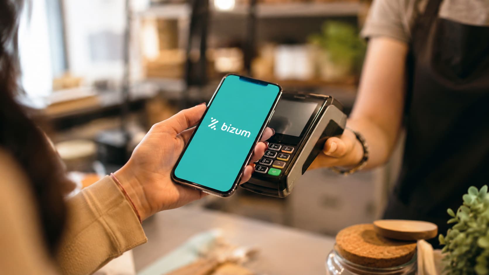 Cliente paga con el móvil en un comercio usando Bizum